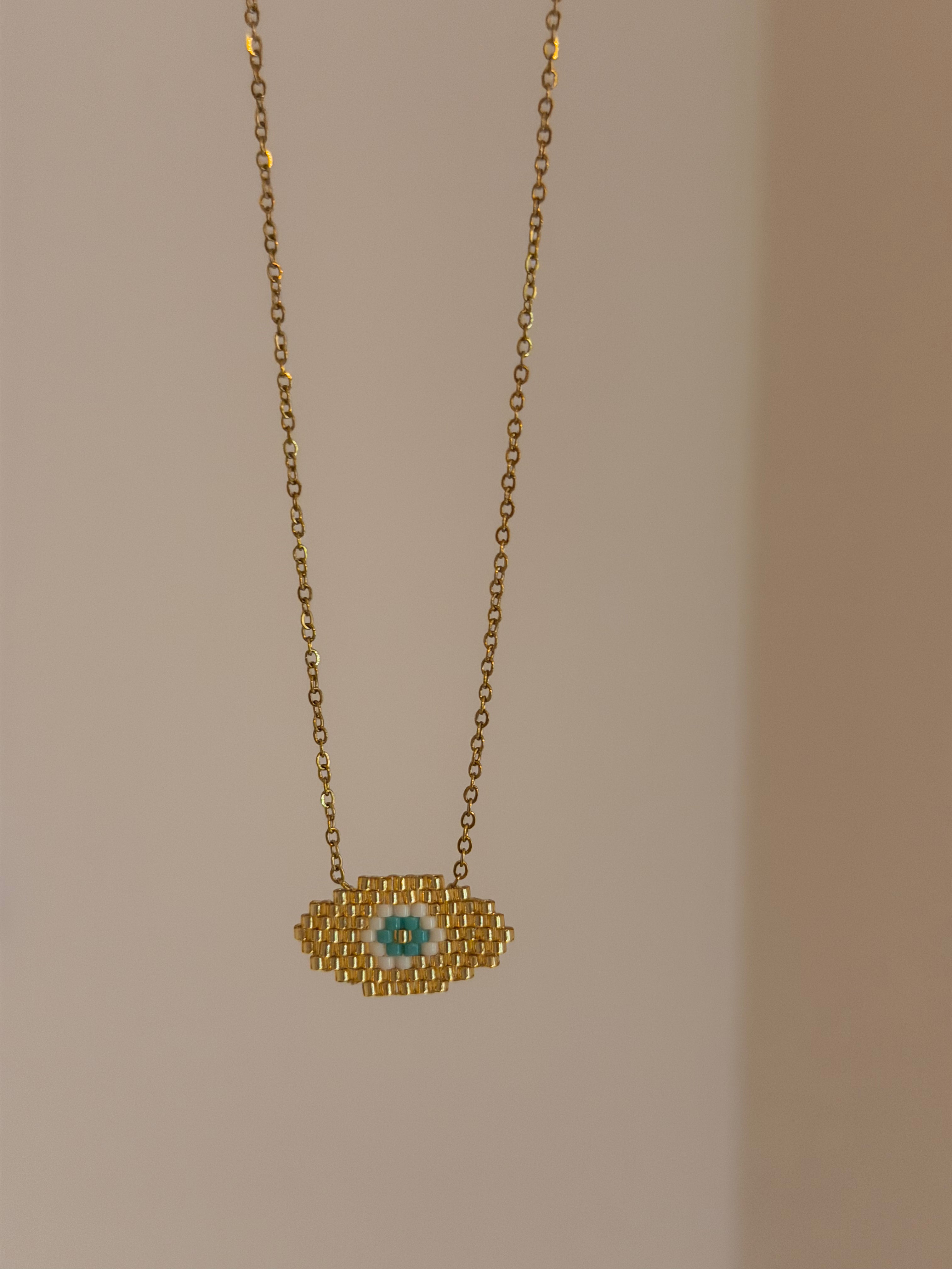 Gold eye necklace